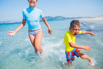 Two happy kids playing on the beach