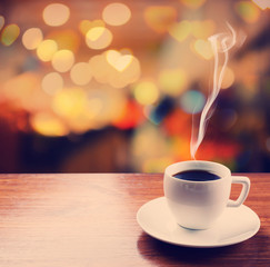 Poster - Cup of coffee on table on blured cafe background