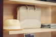 Beige men hat and bag on the shelf in boutique