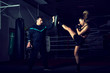 Girl kicking back leg during kickboxing practice