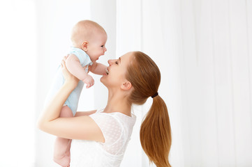 happy family mother playing with baby