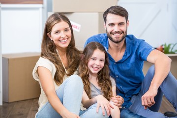 Wall Mural - Portrait of family sitting on floor