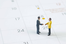 Miniature People Agreement On Calendar Background