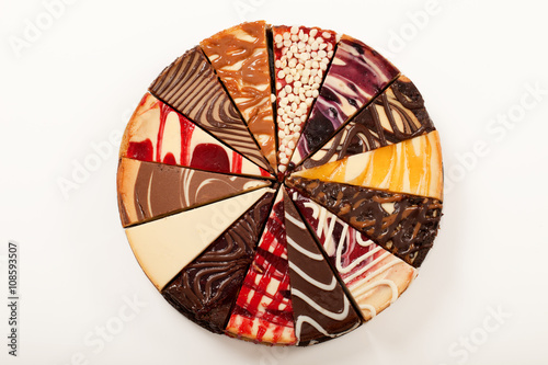 Fotografering  14 different slices of cheesecake to make a complete pie.
