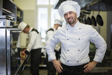 Wall Mural - Cheerful chef in his kitchen