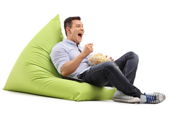 Canvas Print - Guy eating popcorn and watching something