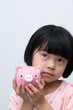 Asian child with piggy bank