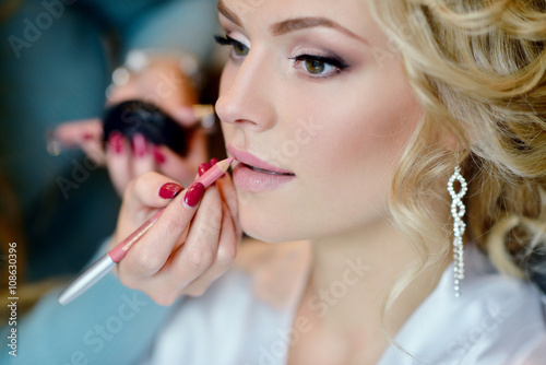 Fotografie, Obraz Wedding makeup artist making a make up for bride