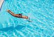 © volff - Woman jumping into the swimming pool.