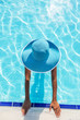 © volff - Woman in sun hat in the swimming pool. Top view.