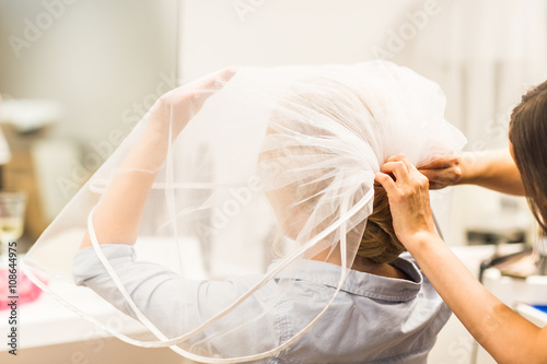 Fotografie, Obraz Hair stylist makes the bride before a wedding