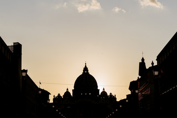 Silhouette of St. Peter's Basilica at sunset in Rome, Italy