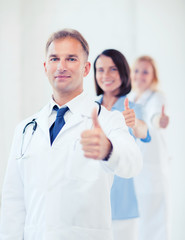 Wall Mural - doctor with stethoscope and colleagues