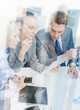 © Syda Productions - business team with tablet pc having discussion