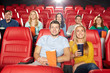© Syda Productions - happy friends watching movie in theater
