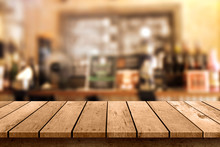 Wooden Table With A View Of Blurred Beverages Bar Backdrop