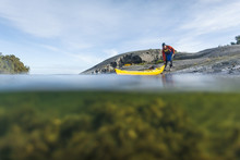 Person with kayak at sea