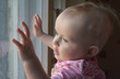 © jordano - Cute baby  in  room stands near window