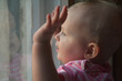© jordano - Cute baby  in  room stands near window