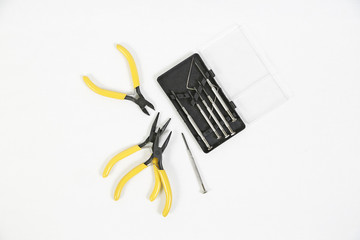 Pliers and screwdriver on white background