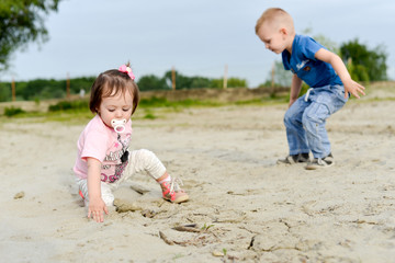 Kids are playing in the sand