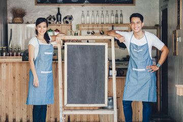 happy two small business owner ready to open their cafe