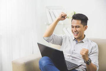 happy young man raise his hand. success