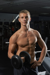 Guy with dumbbells in the gym