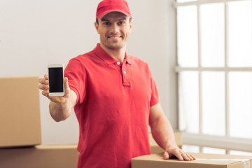 Wall Mural - Handsome worker helping to move