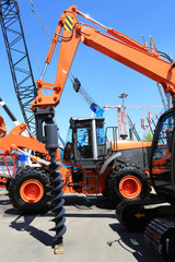 Construction yellow machine with a large drill for wells