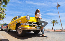 Young Beautiful Woman With Retro Yellow Car.
