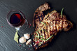 Steak with spices and glass of red wine