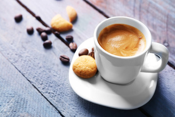 Cup of coffee on wooden table background