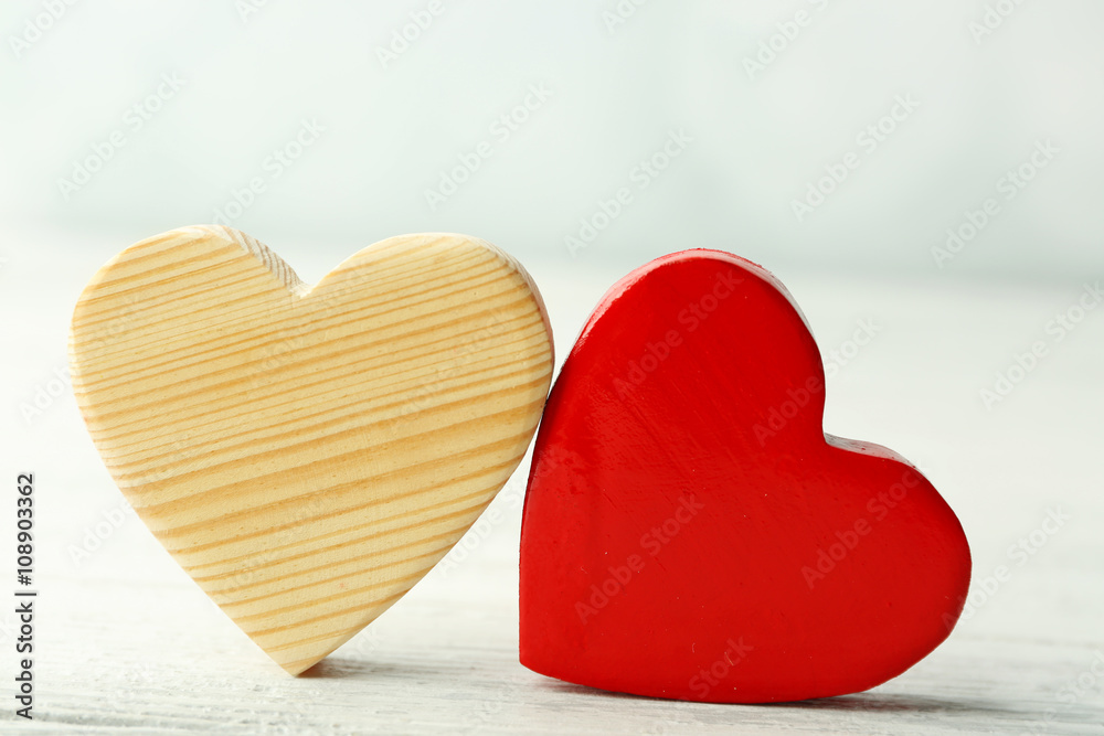 Wooden hearts on light background
