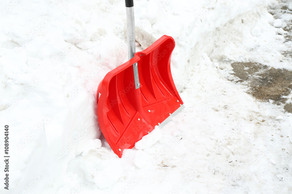 Winter concept. Red shovel for snow removal