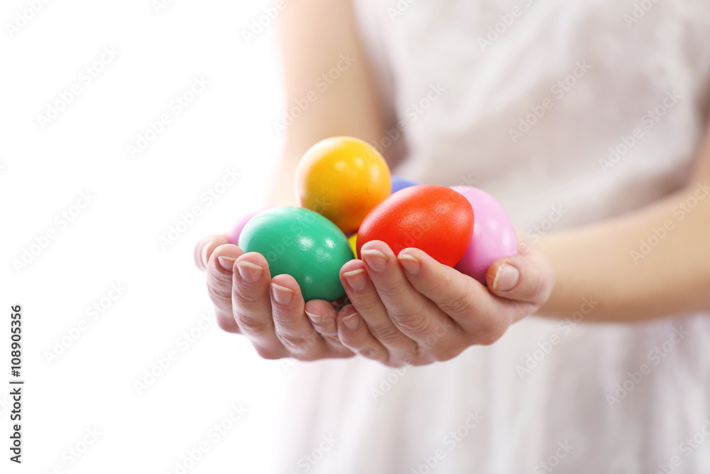Female hands holding Easter eggs isolated on white