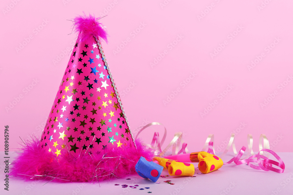Pink party hat on pink background