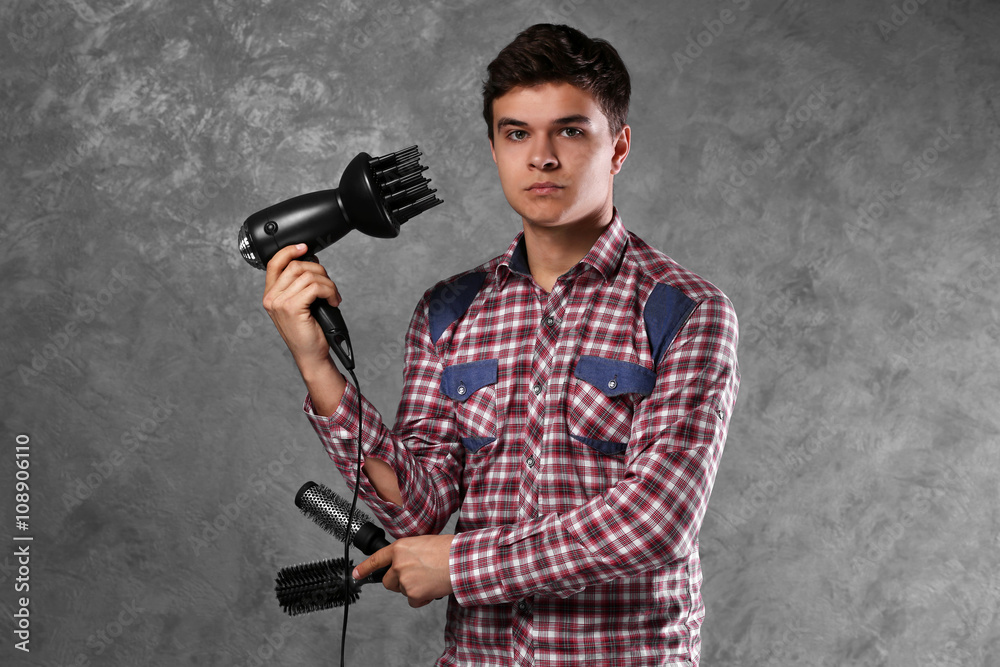 Handsome man with comb and hairdryer