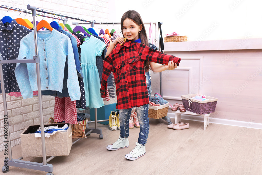 Little girl trying on a new shirt