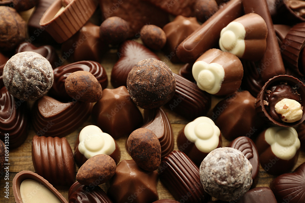Assortment of delicious chocolate candies background, close up