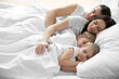 Family sleeping in bed, closeup