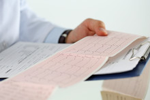Male Medicine Doctor Hands Holding Cardiogram Chart