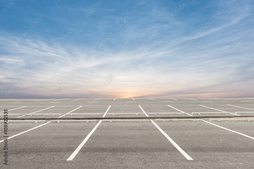 Empty parking lot on sunset background - obrazy, fototapety, plakaty 