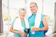 © WavebreakmediaMicro - Portrait of smiling senior couple holding bottle