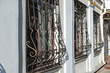 Metal wrought-iron bars on  windows of apartment house