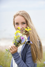 Smiling Teenage Girl Holding Wildflowers