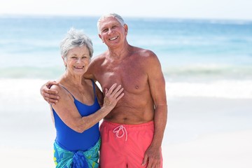 Wall Mural - Cute mature couple embracing on the beach