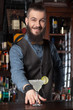 © Dmytro Panchenko - Barman serving cocktail.