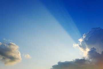 Wall Mural - light of sunbeams through clouds, light rays on dramatic sunset
