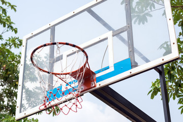 Closeup of the basketball hoop in the park.